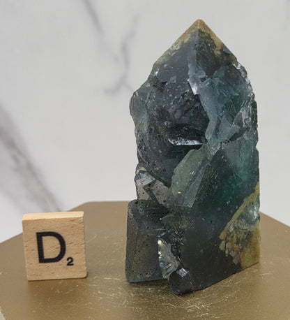 Fluorite crystal on a wooden stand with a marble background