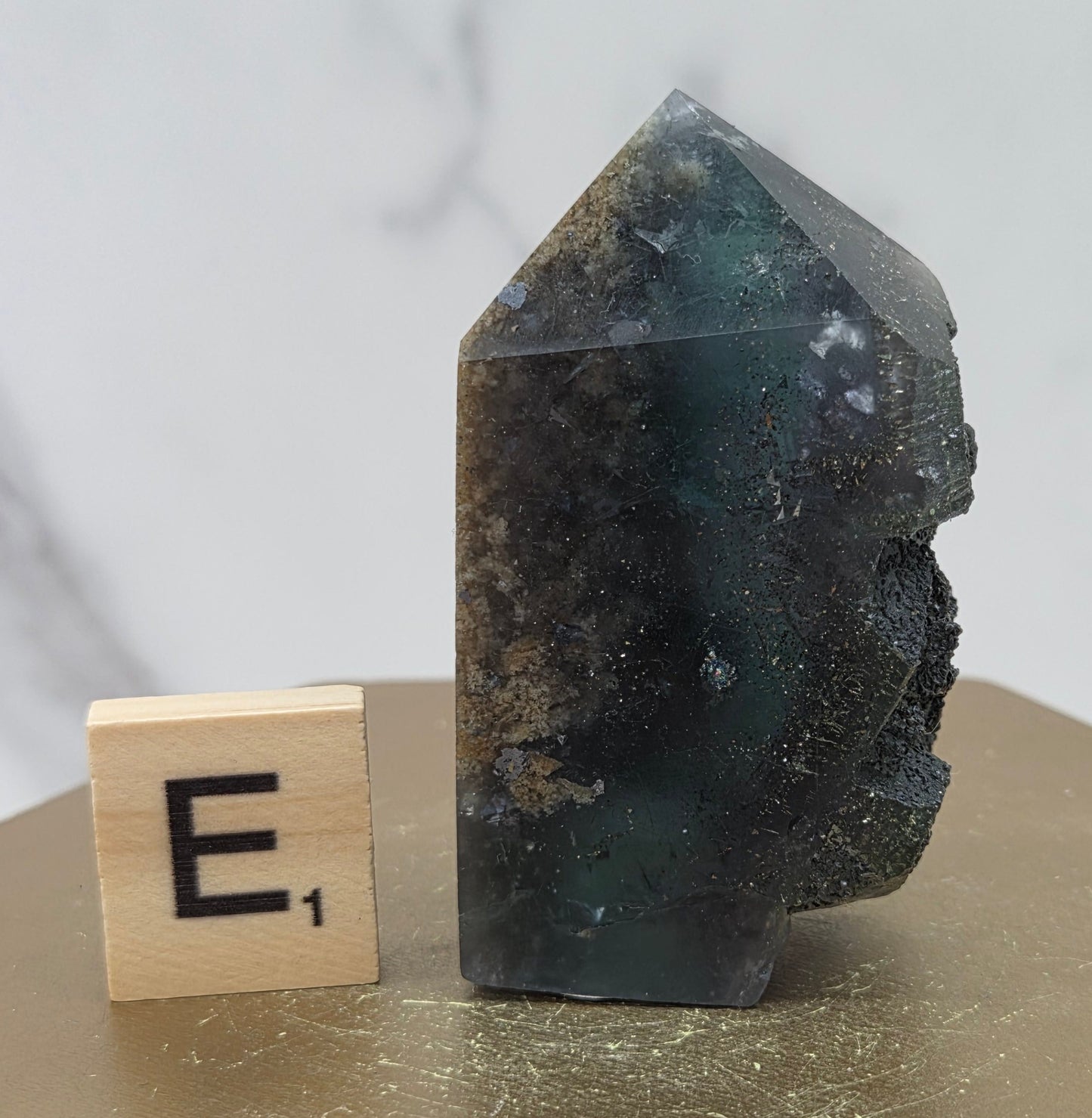 Fluorite crystal on a wooden stand with a marble background