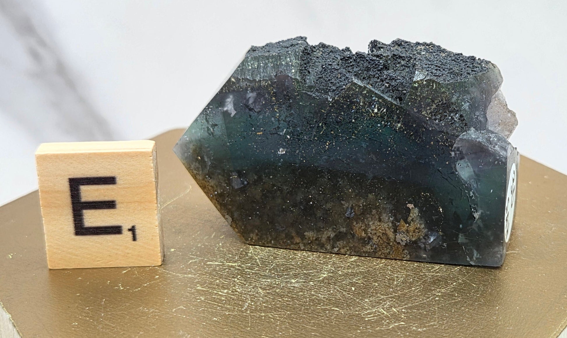 Fluorite crystal on a wooden stand with a marble background