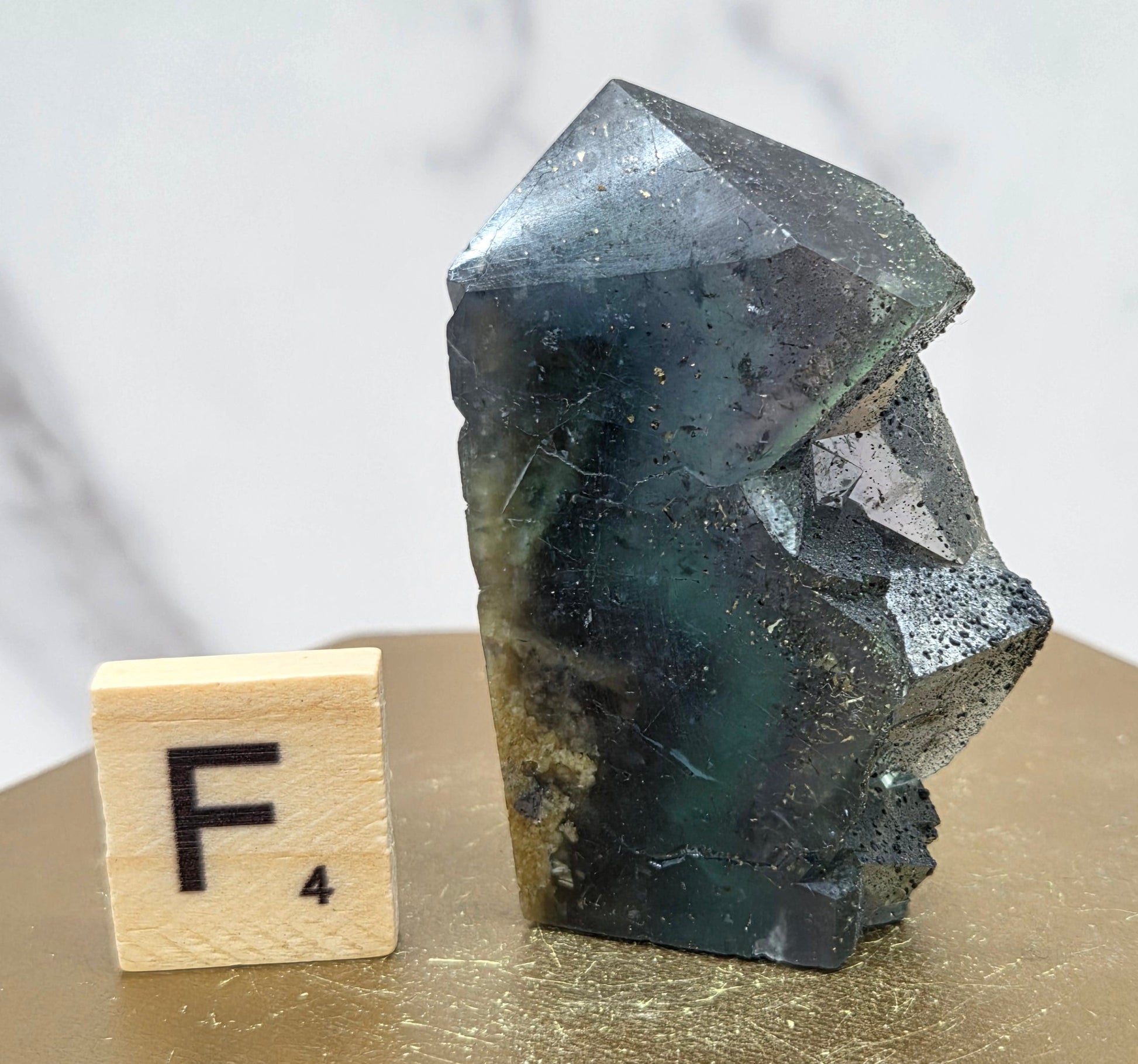 Fluorite crystal on a wooden stand with a marble background