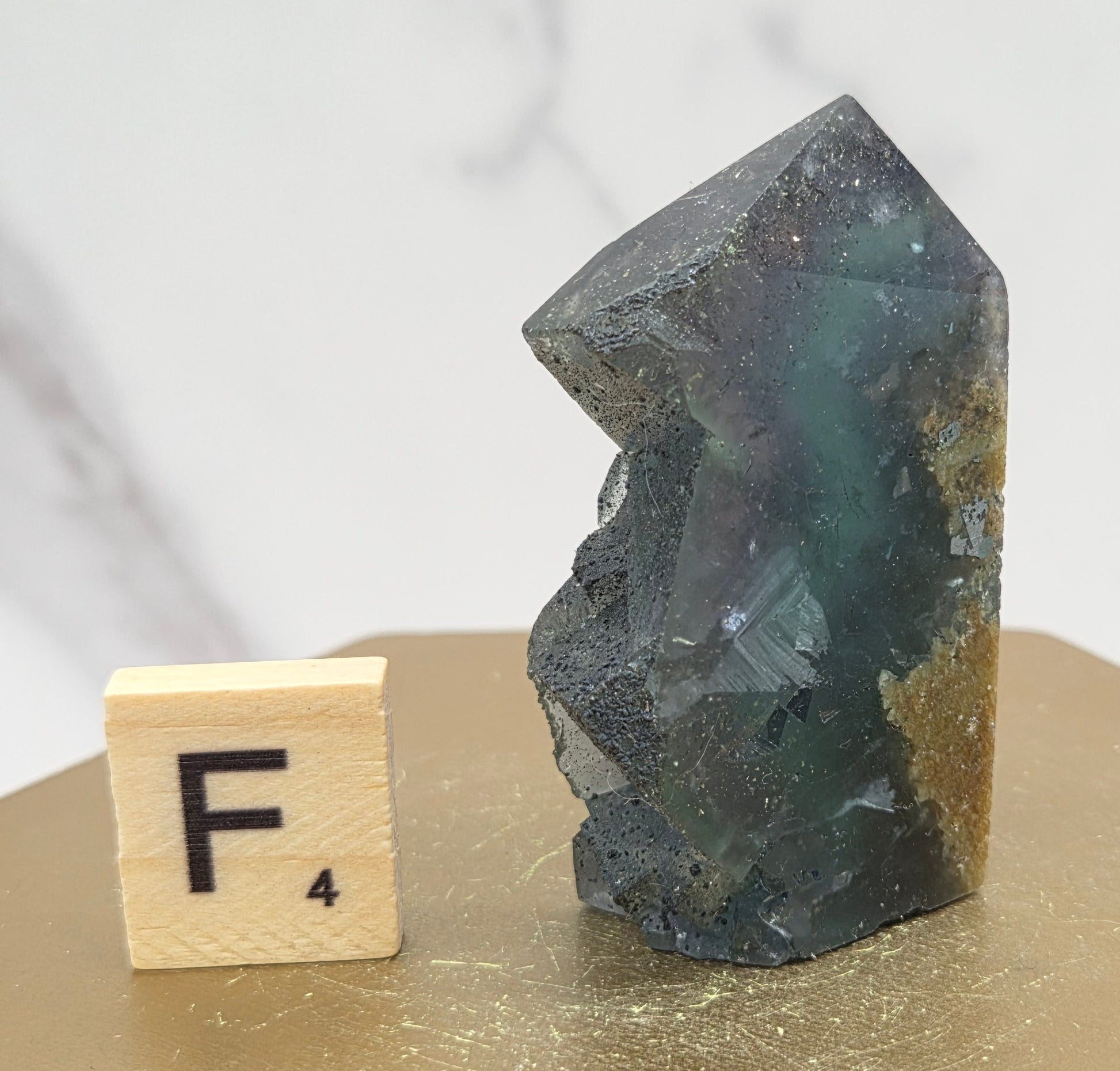 Fluorite crystal on a wooden stand with a marble background