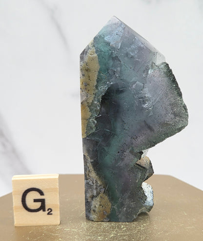 Fluorite crystal on a wooden stand with a marble background