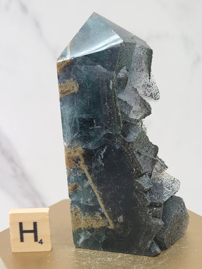 Fluorite crystal on a wooden stand with a marble background