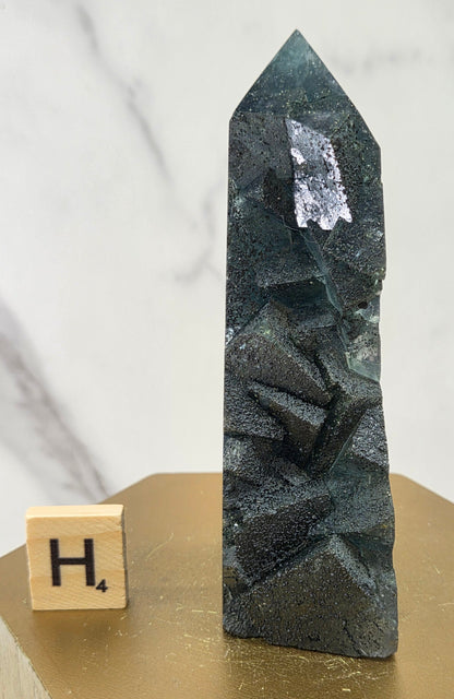 Fluorite crystal on a wooden stand with a marble background