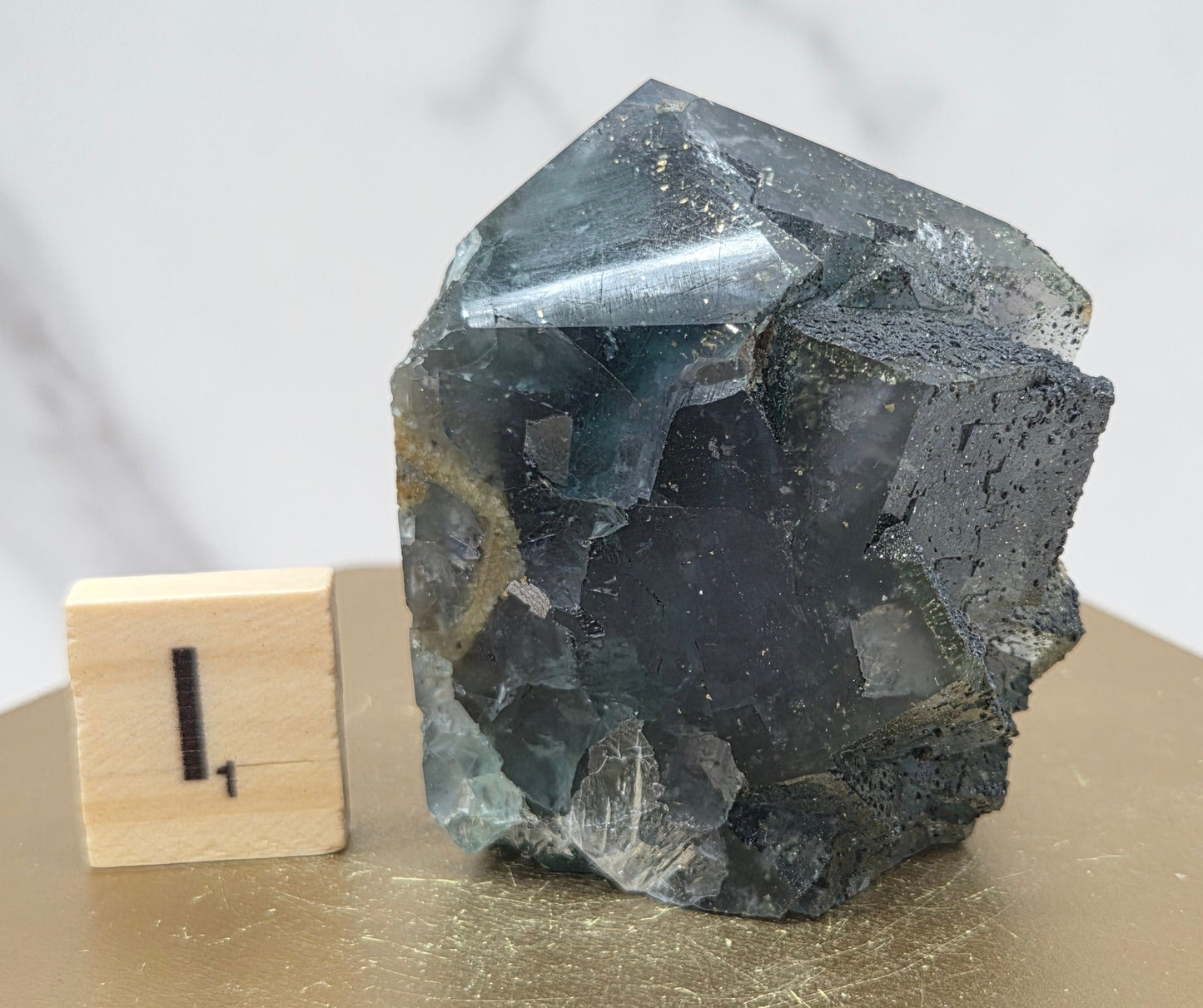 Fluorite crystal on a wooden stand with a marble background