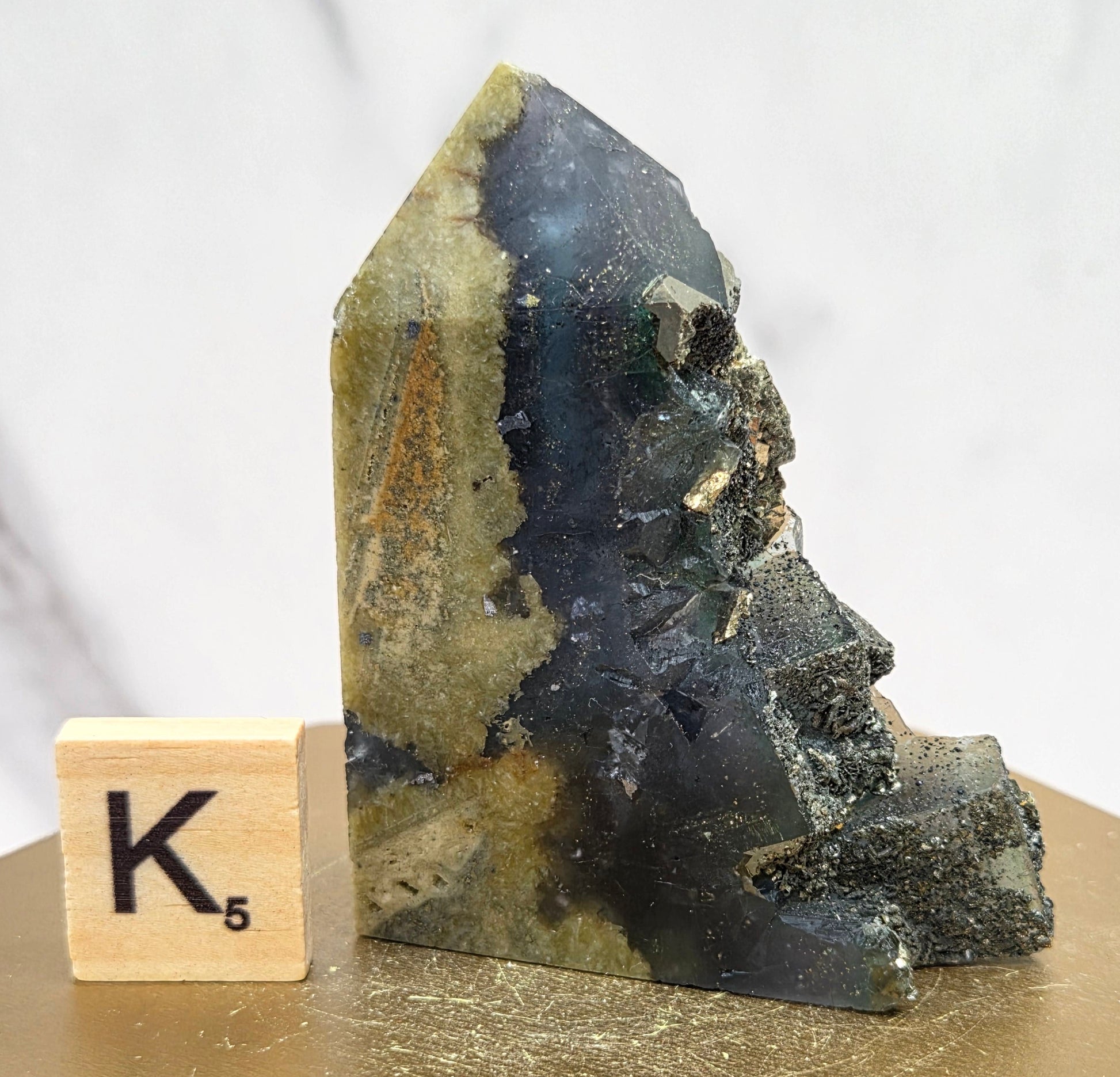 Fluorite crystal on a wooden stand with a marble background