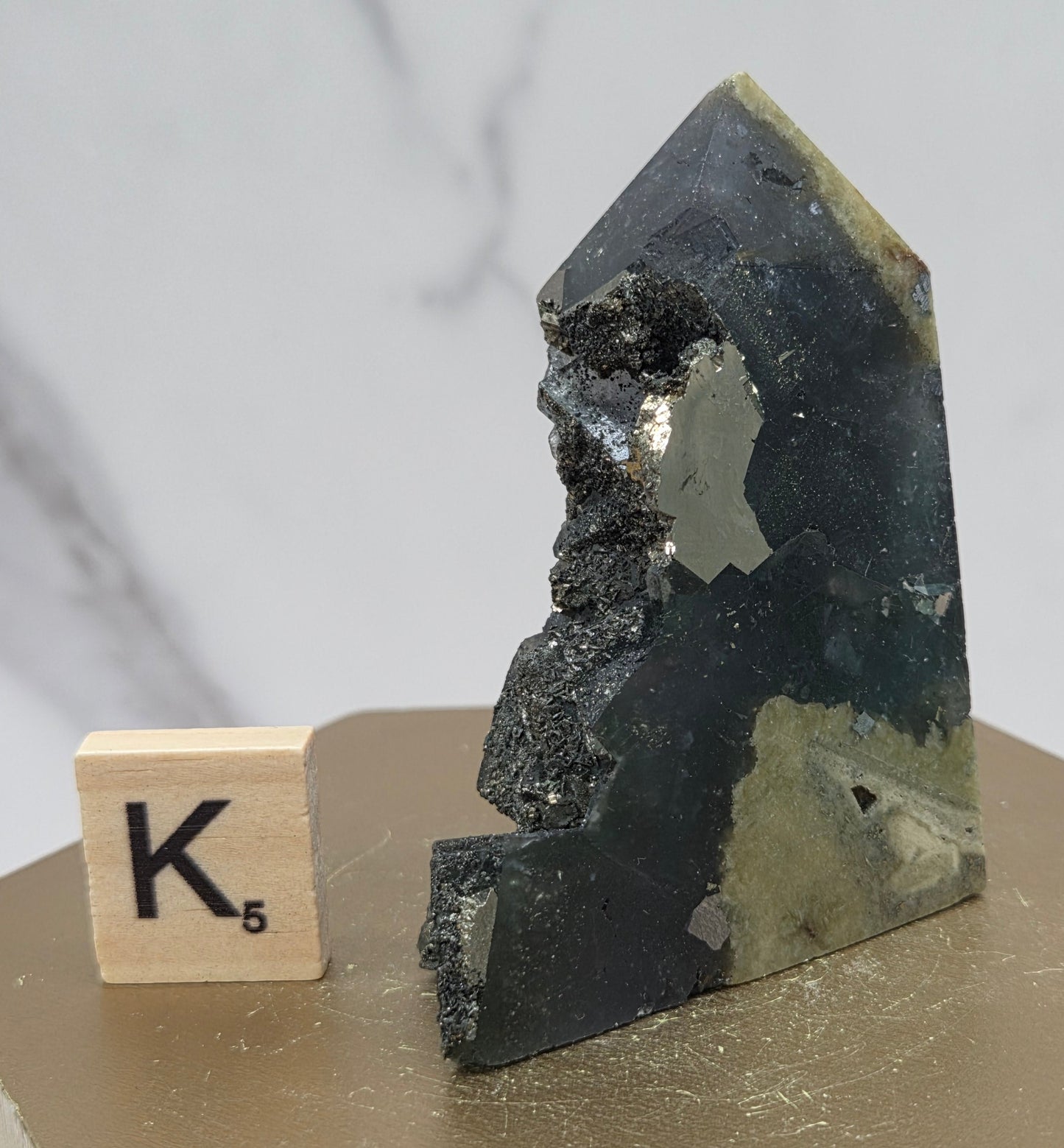 Fluorite crystal on a wooden stand with a marble background