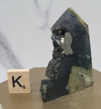 Fluorite crystal on a wooden stand with a marble background
