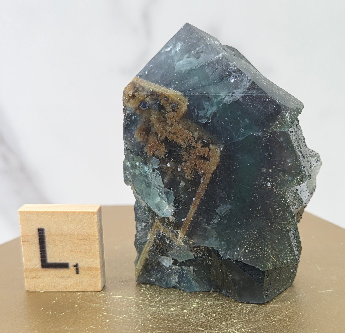 Fluorite crystal on a wooden stand with a marble background
