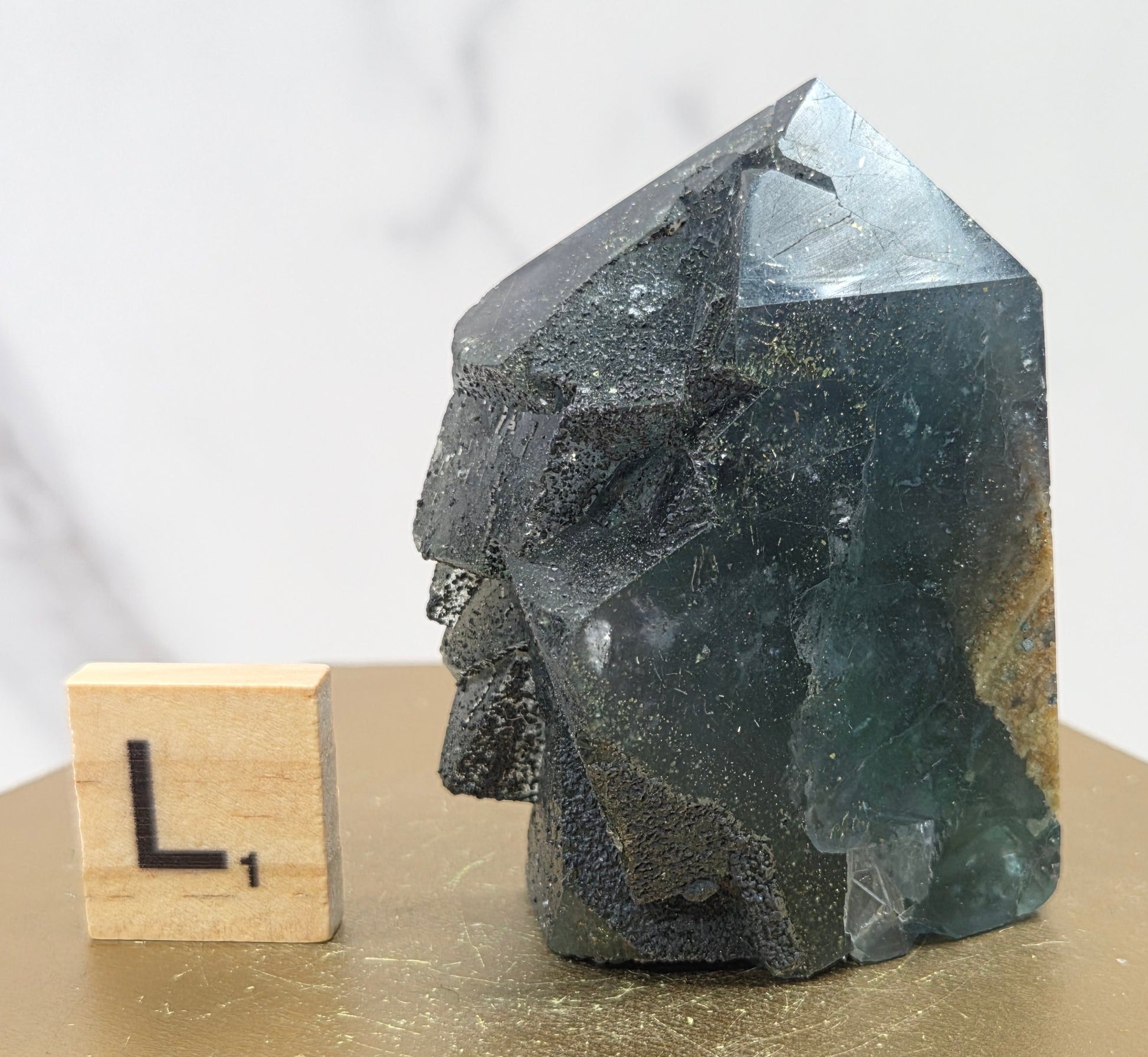 Fluorite crystal on a wooden stand with a marble background