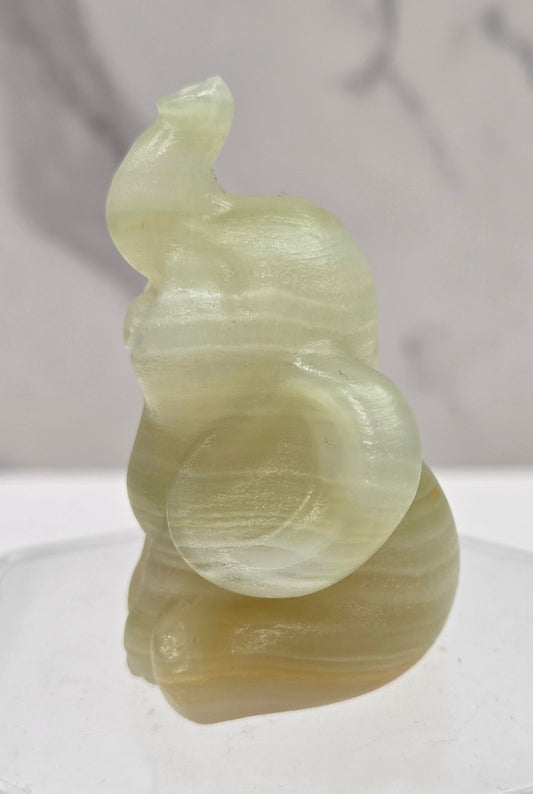 Decorative afghan jade sculpture of an elephant on a white background