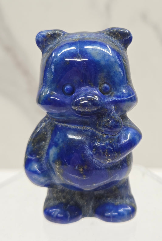 Blue Lapis carving of Pooh Bear on a white background