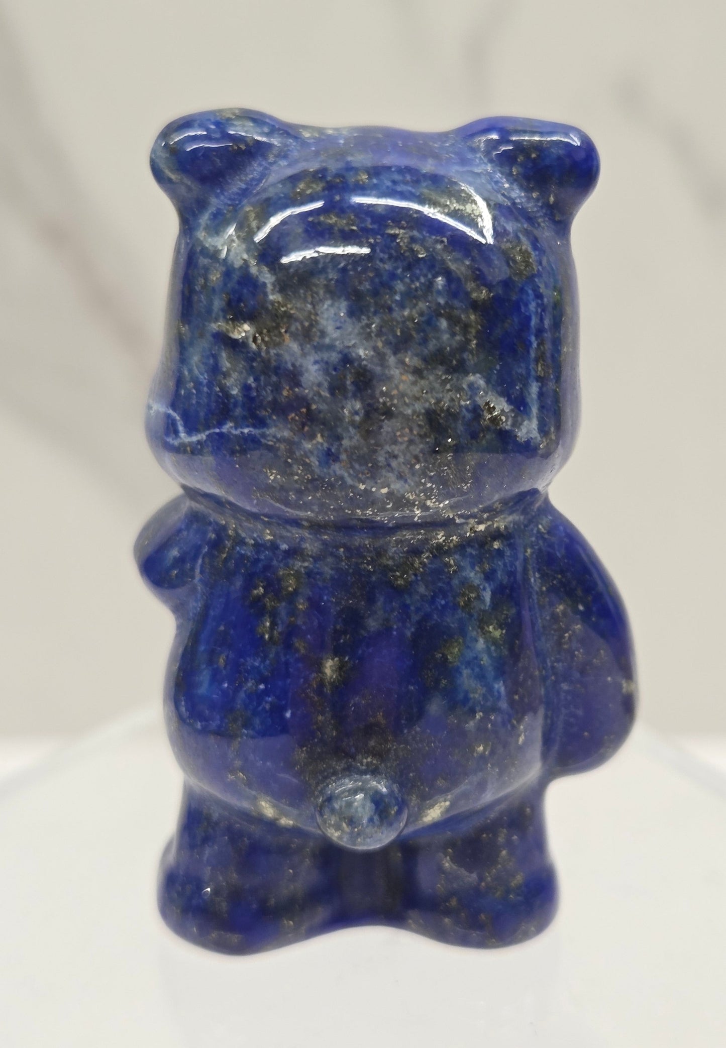 Blue Lapis carving of Pooh Bear on a white background