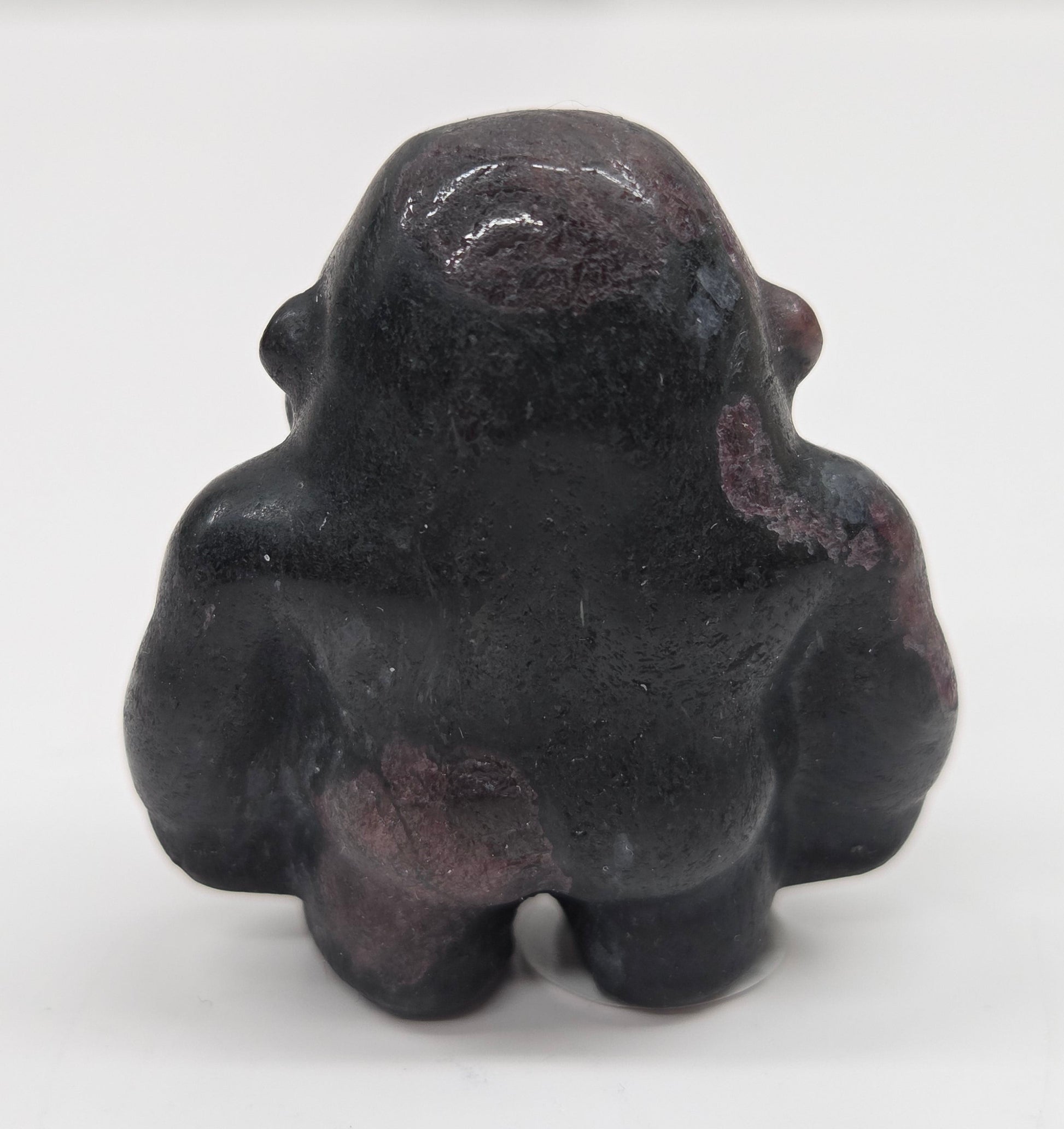 Black with red Garnet gorilla figurine on a white background