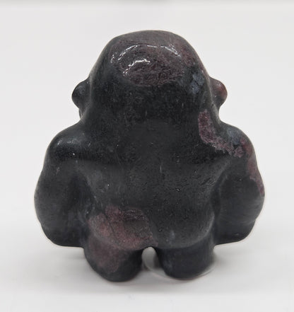 Black with red Garnet gorilla figurine on a white background