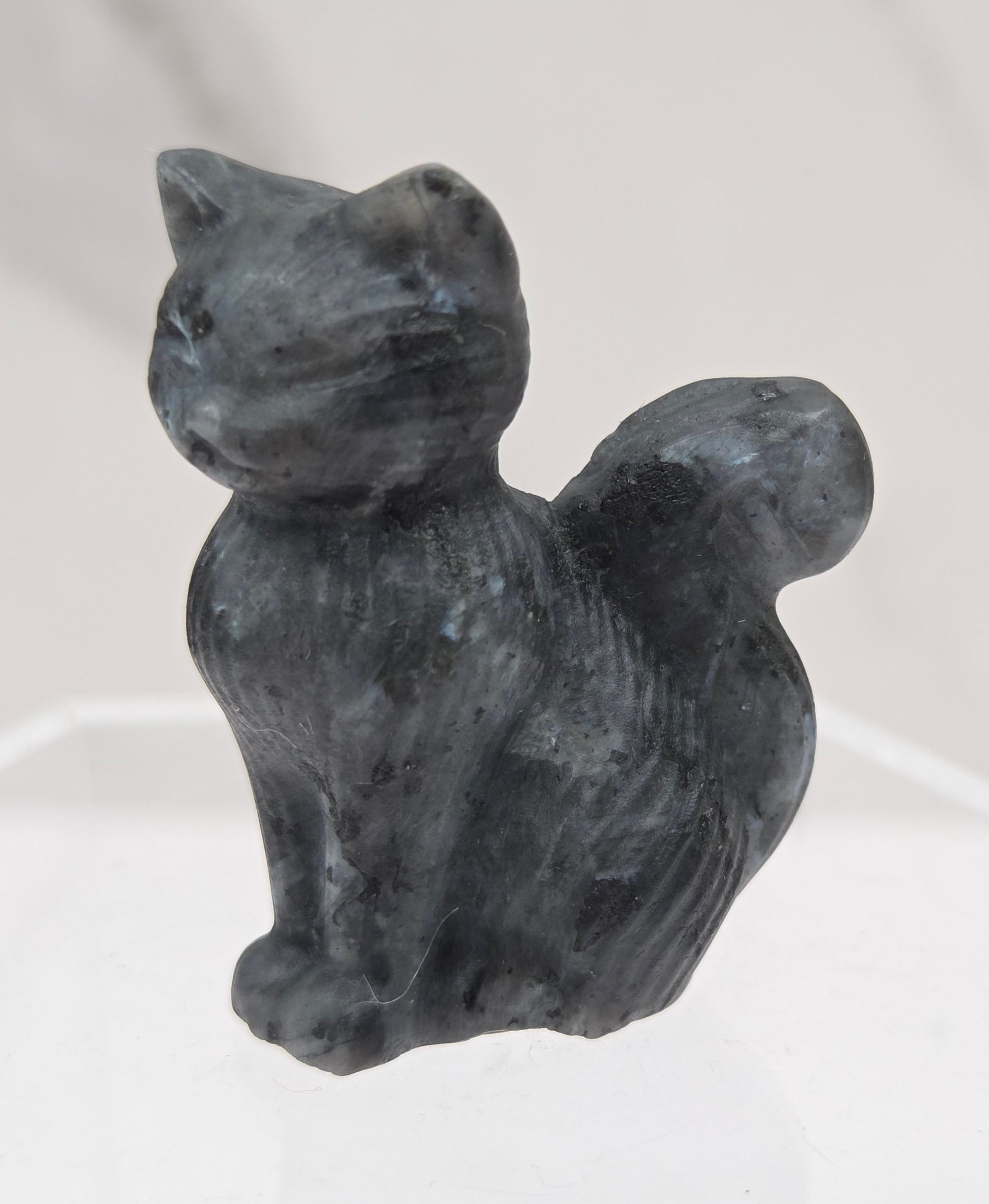 small Larvakite sculpture of a cat against a neutral background