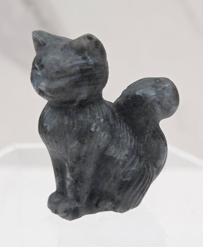 small Larvakite sculpture of a cat against a neutral background