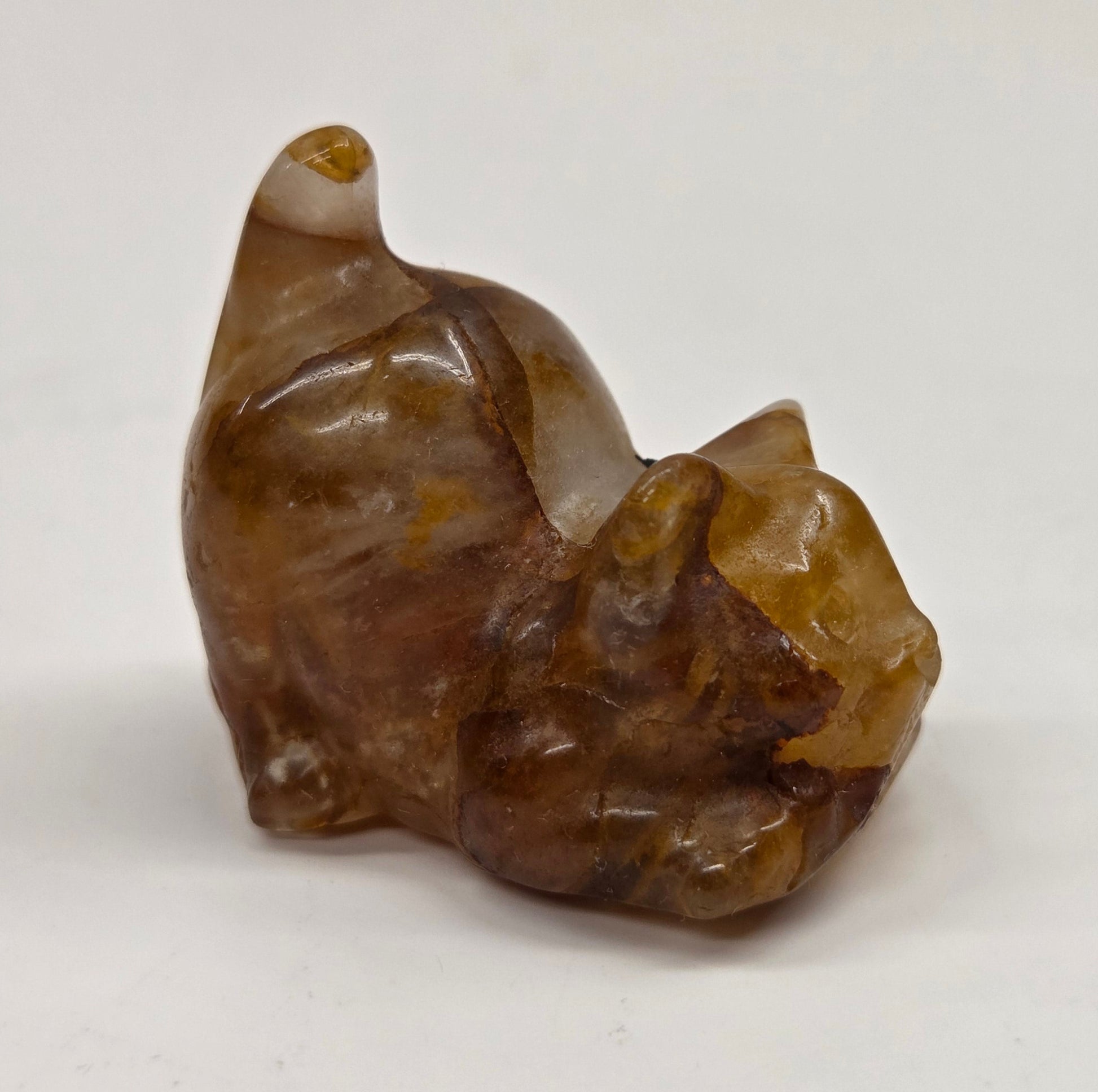 Cat-shaped carvings in Golden Healer, displayed against a white background.