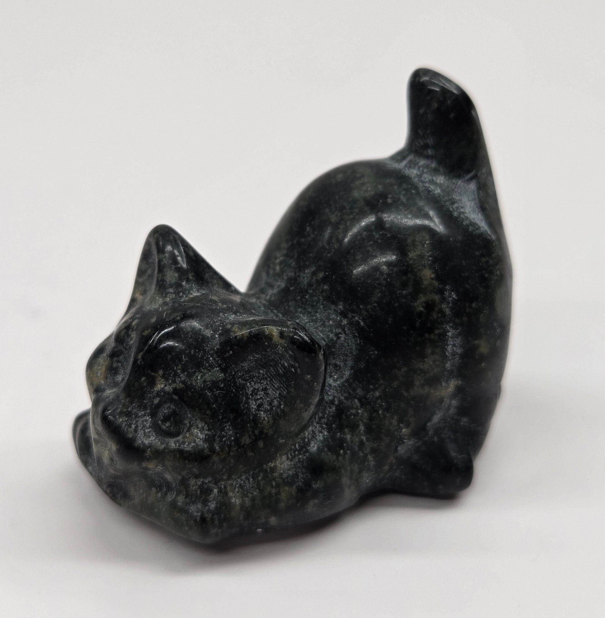 Cat-shaped carvings in dark Green Jade, displayed against a white background.