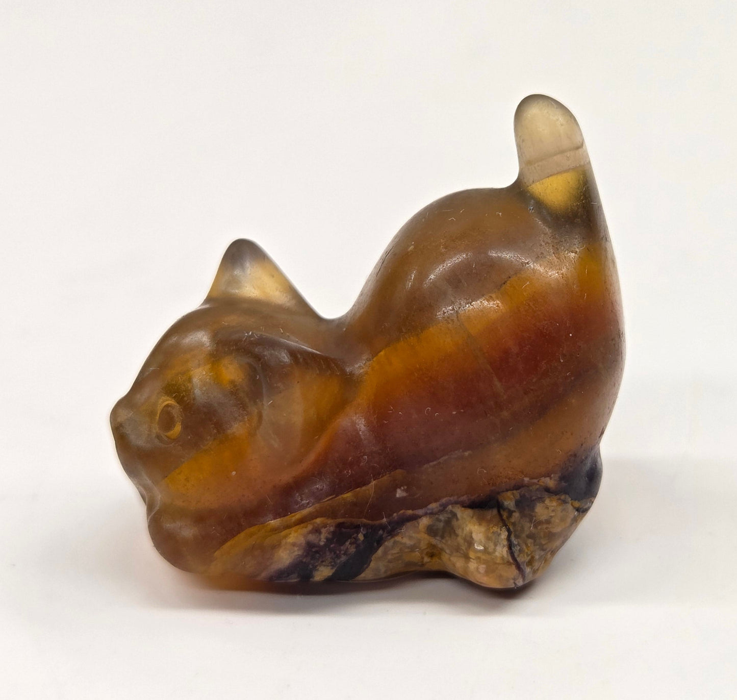 Cat-shaped carvings in Yellow Fluorite, displayed against a white background.