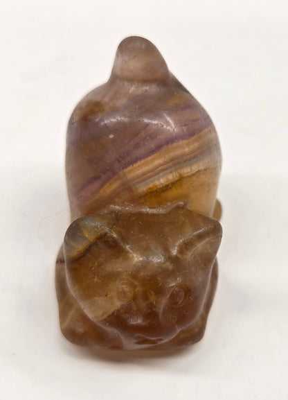 Cat-shaped carvings in Yellow Fluorite, displayed against a white background.