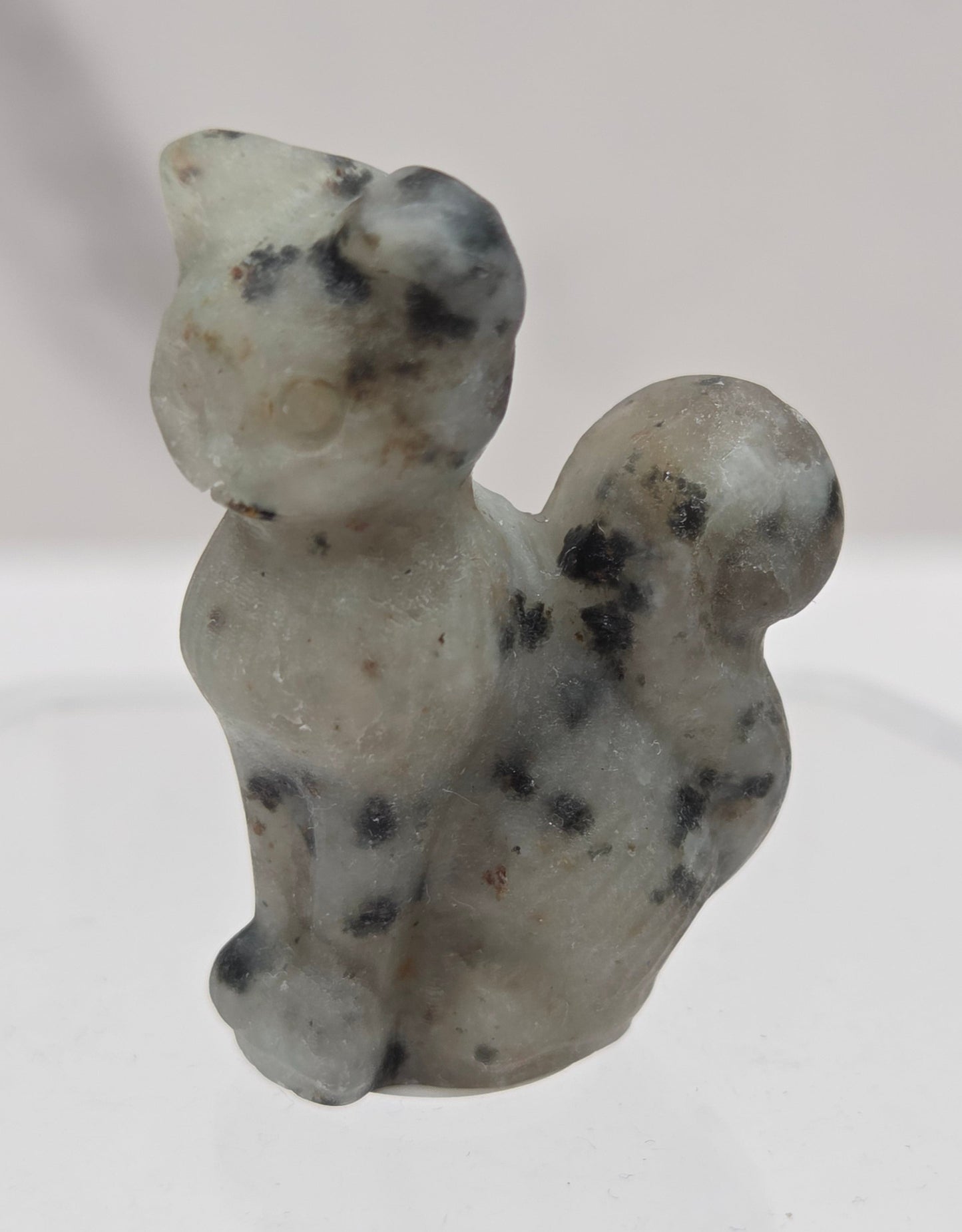 small spotted Kiwi Jasper sculpture of a cat against a neutral background