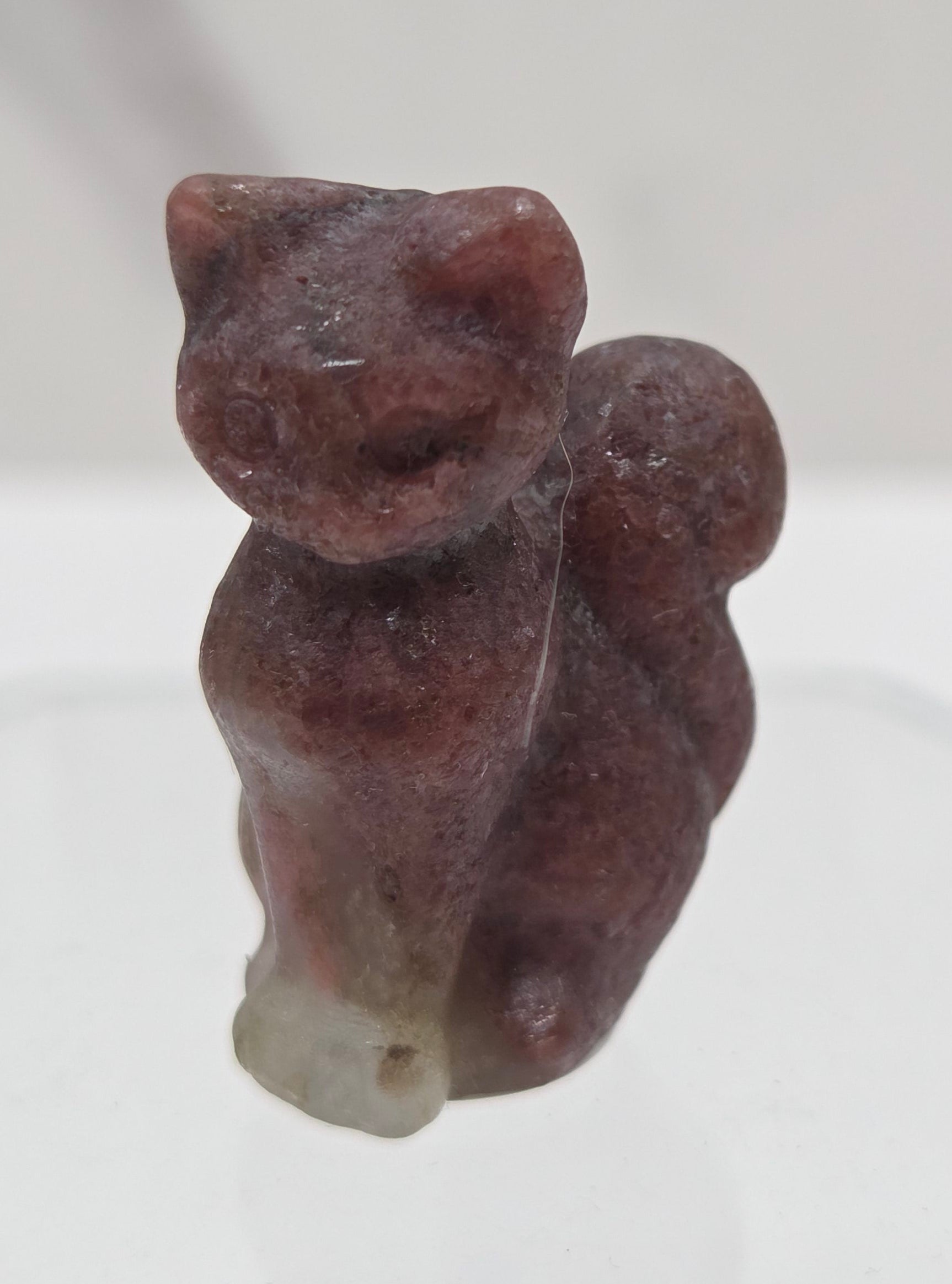 small Pink Tourmaline sculpture of a cat against a neutral background