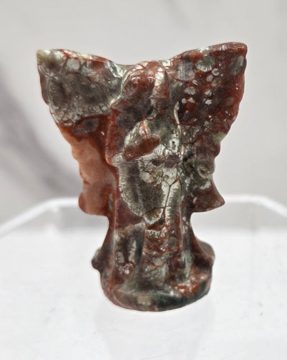 Small Money Agate angel carving on a white background