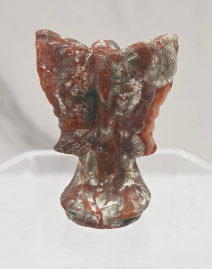Small Money Agate angel carving on a white background
