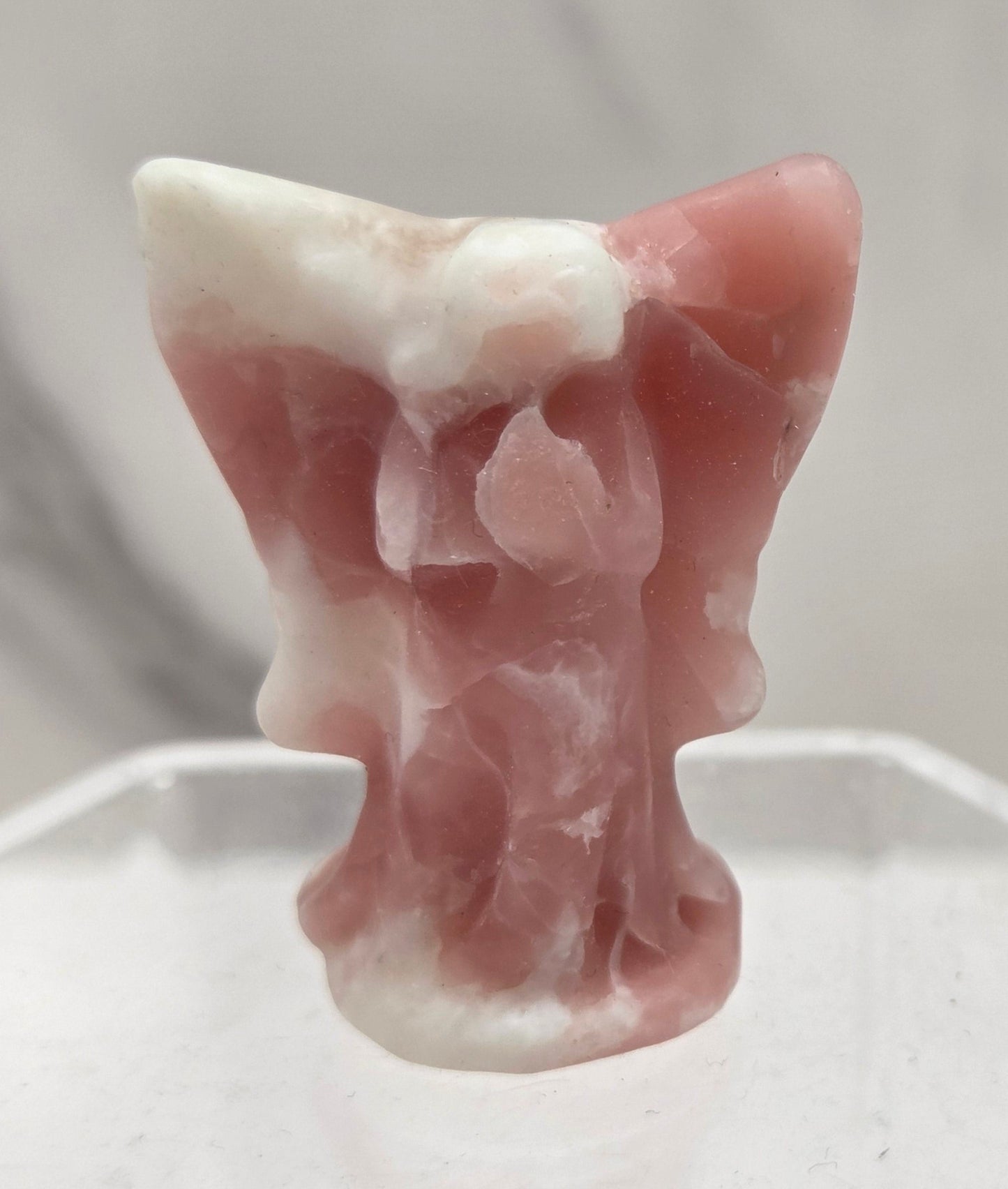 Small Pink Opal angel carving on a white background
