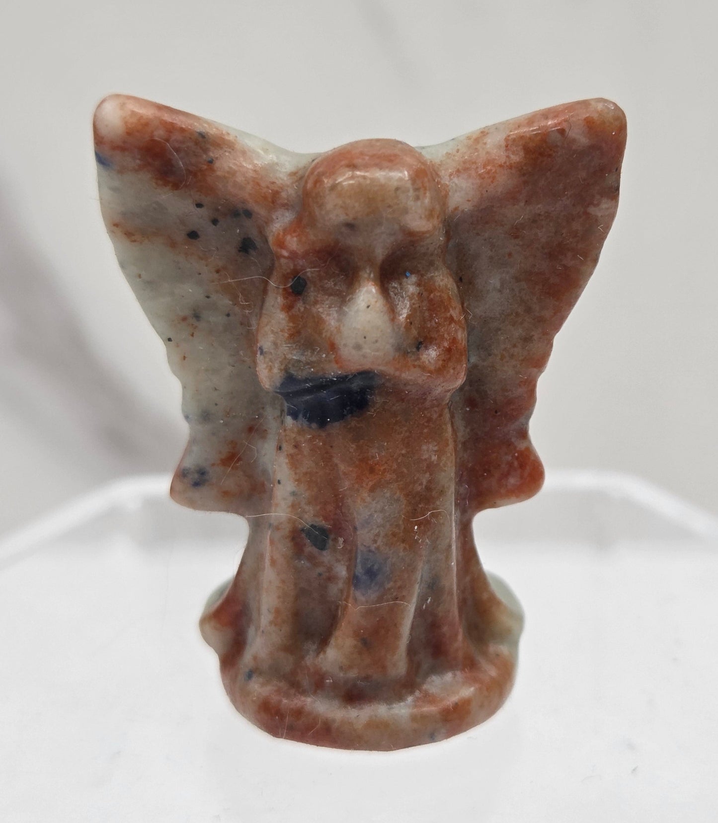 Small Sodalite angel carving on a white background