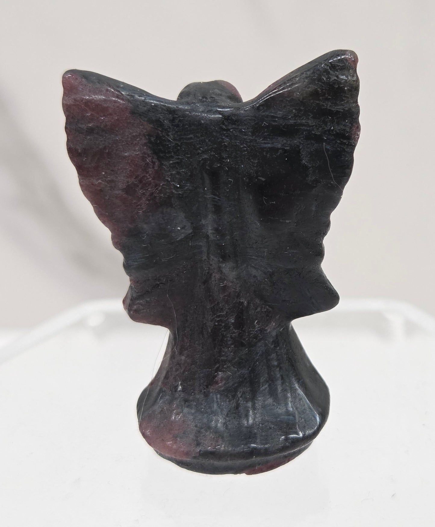 Small Garnet angel carving on a white background