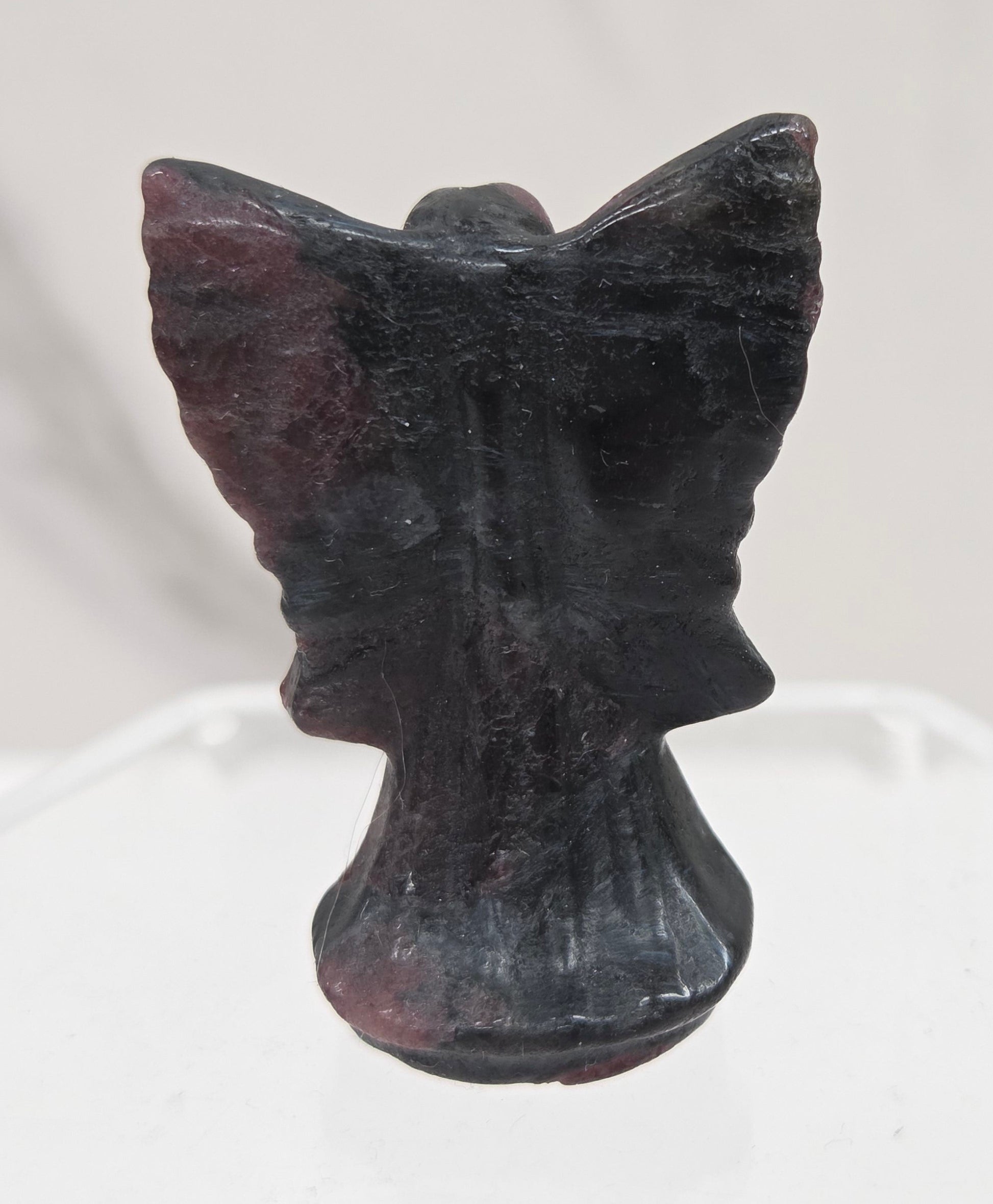 Small Garnet angel carving on a white background