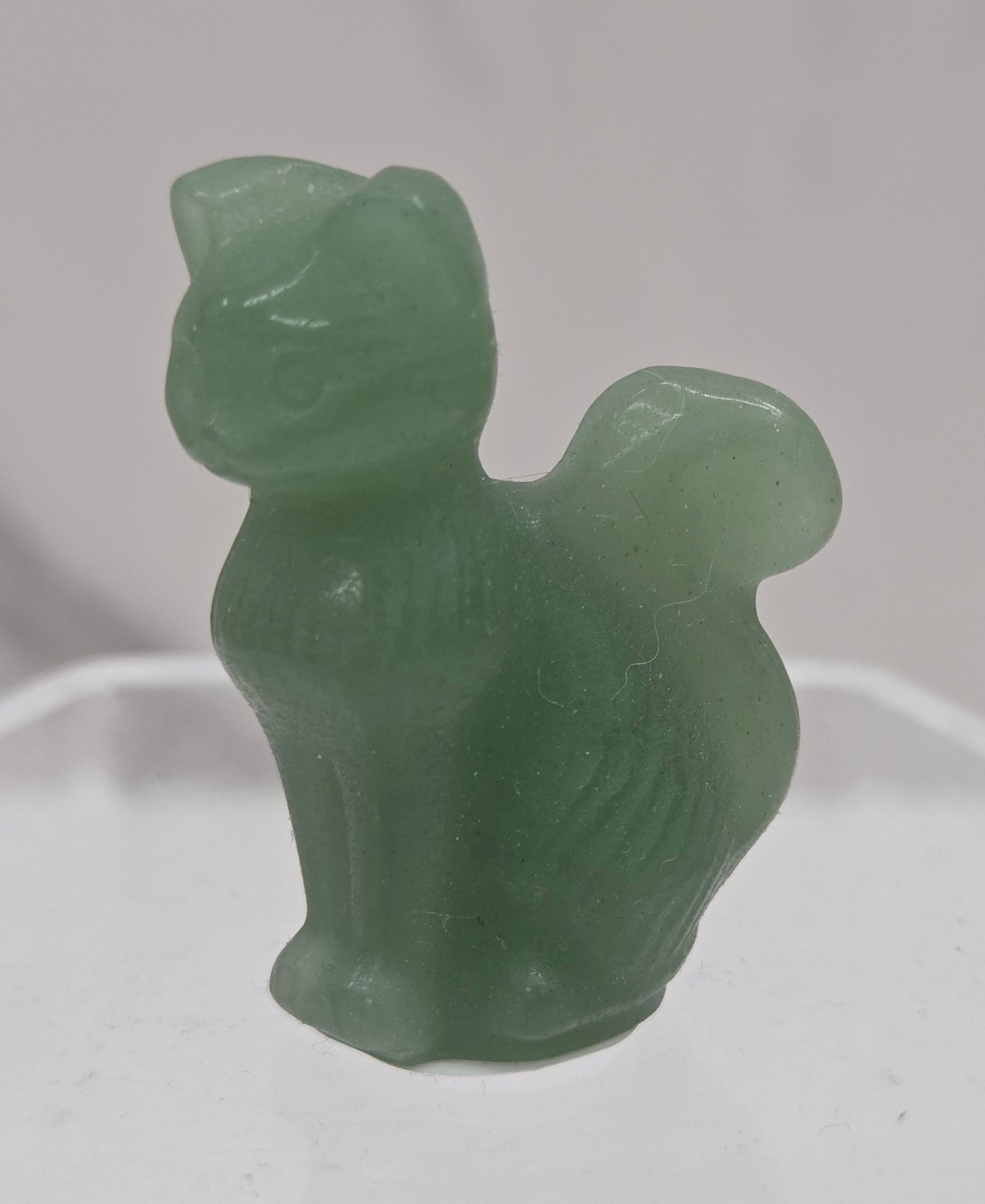 small Green Aventurine sculpture of a cat against a neutral background