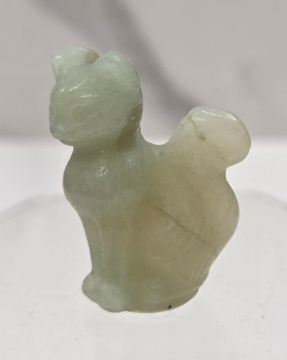 small Caribbean Calcite sculpture of a cat against a neutral background