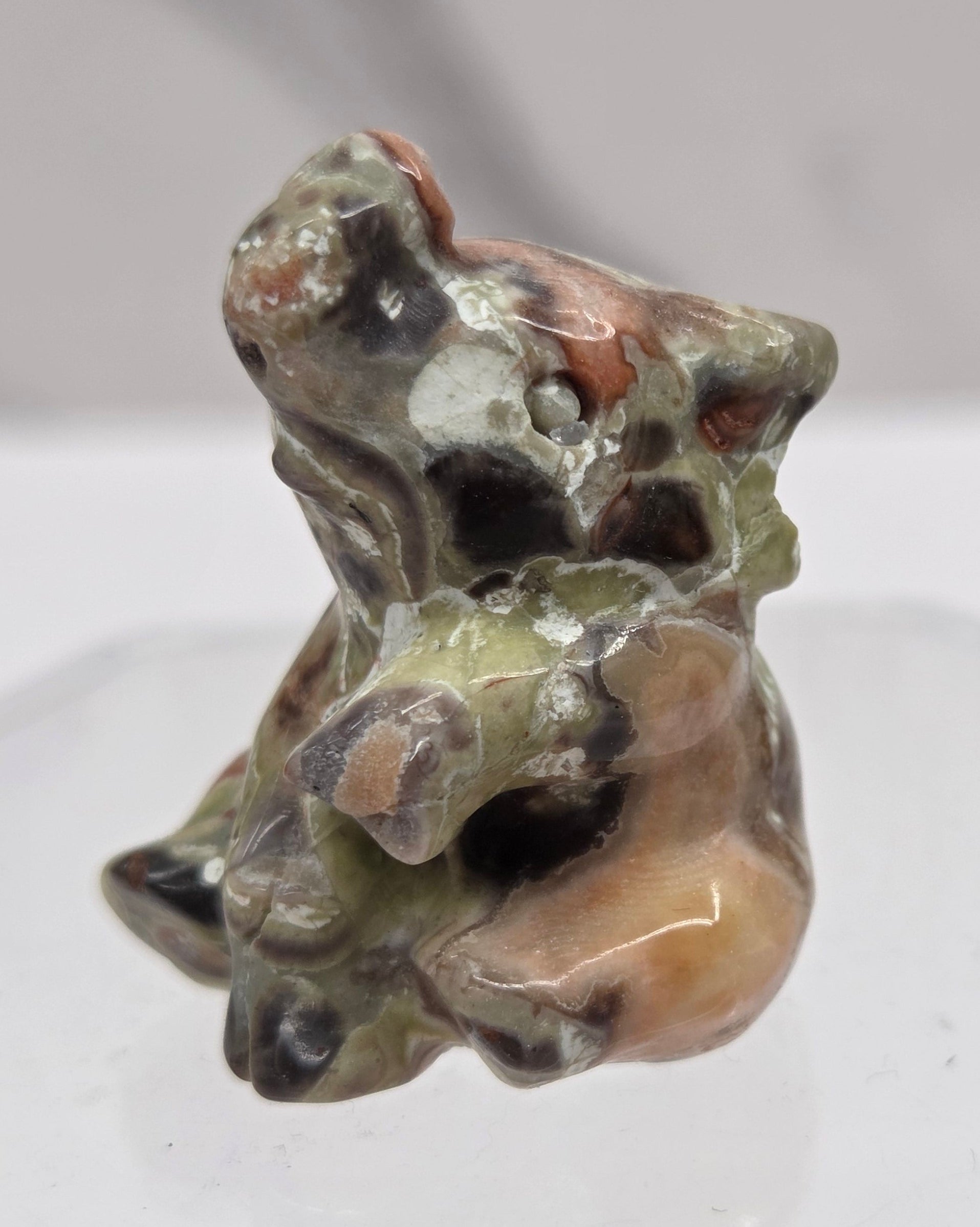 Money Agate sitting elephant carving on a white background