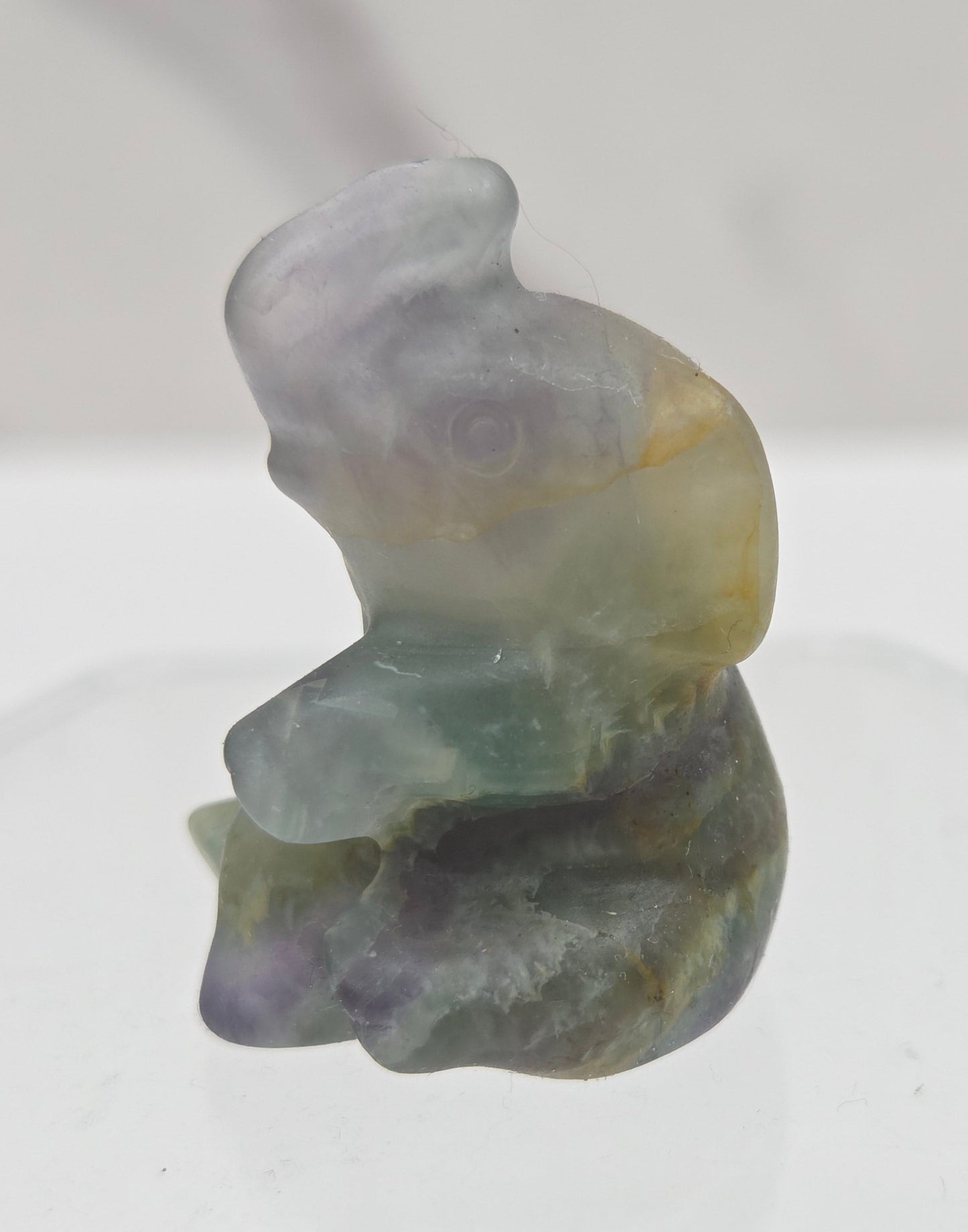 Multicolored Fluorite elephant figurine on a white background