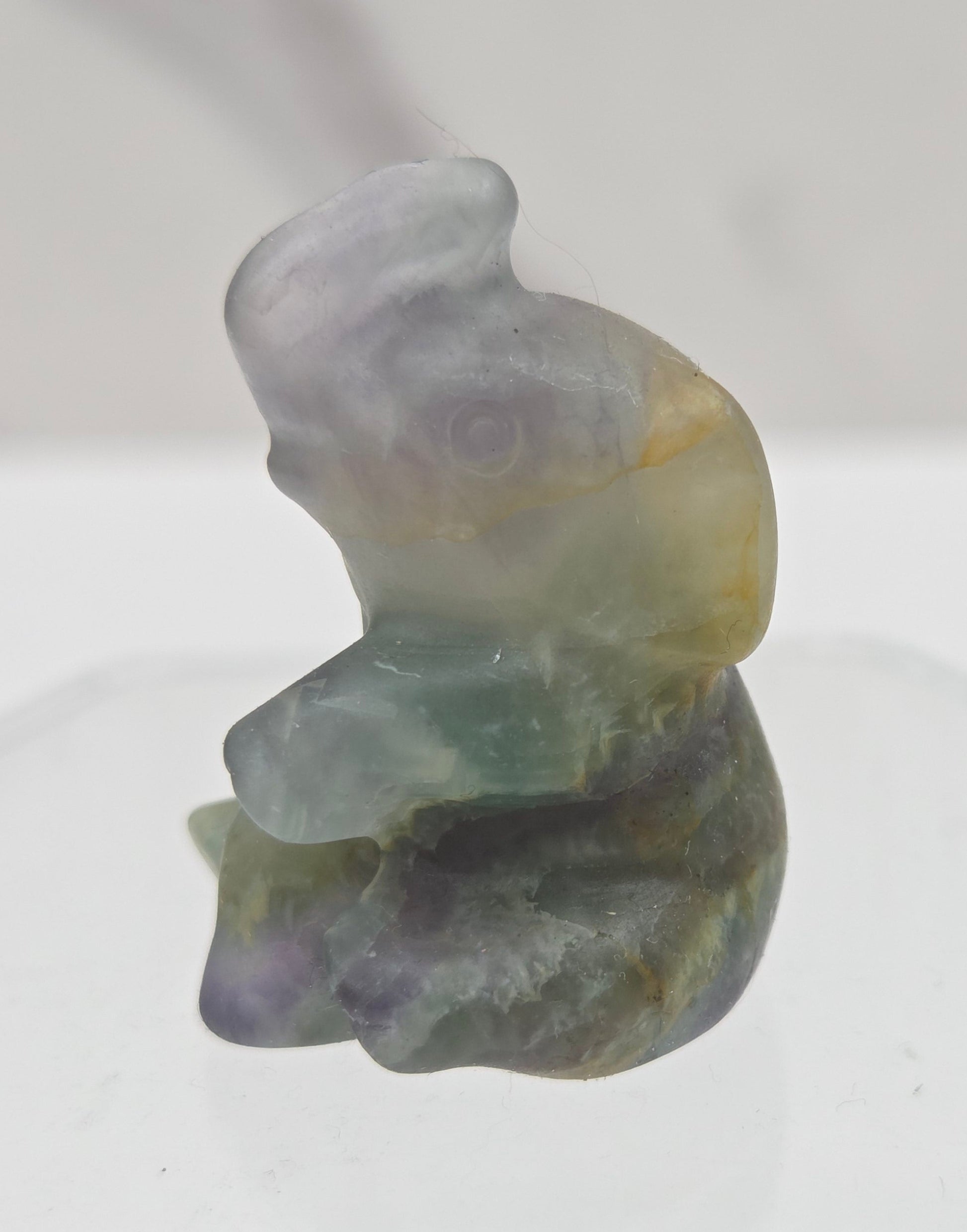 Multicolored Fluorite elephant figurine on a white background