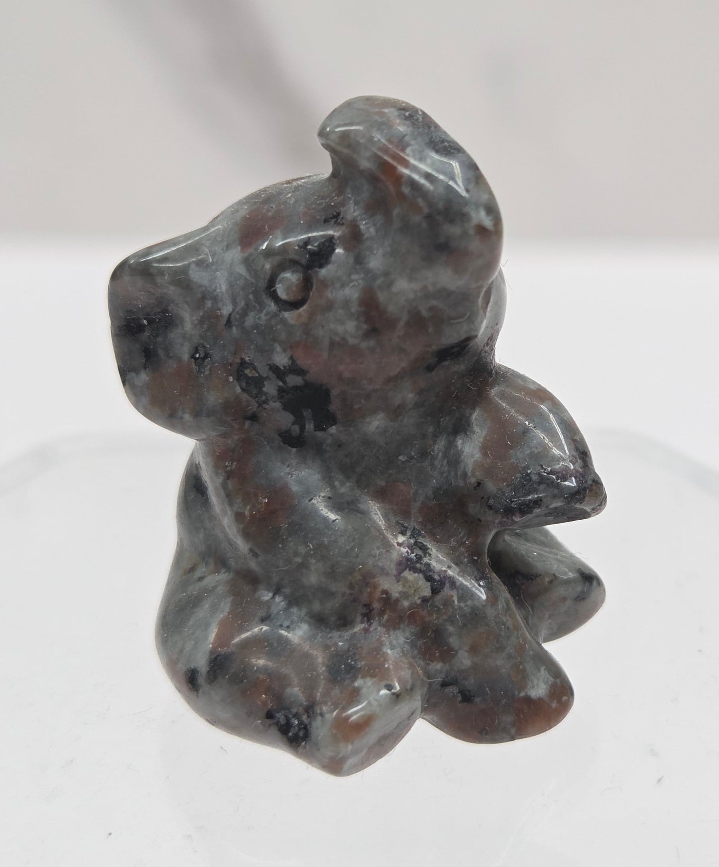Multicolored sitting elephant carving on a white background