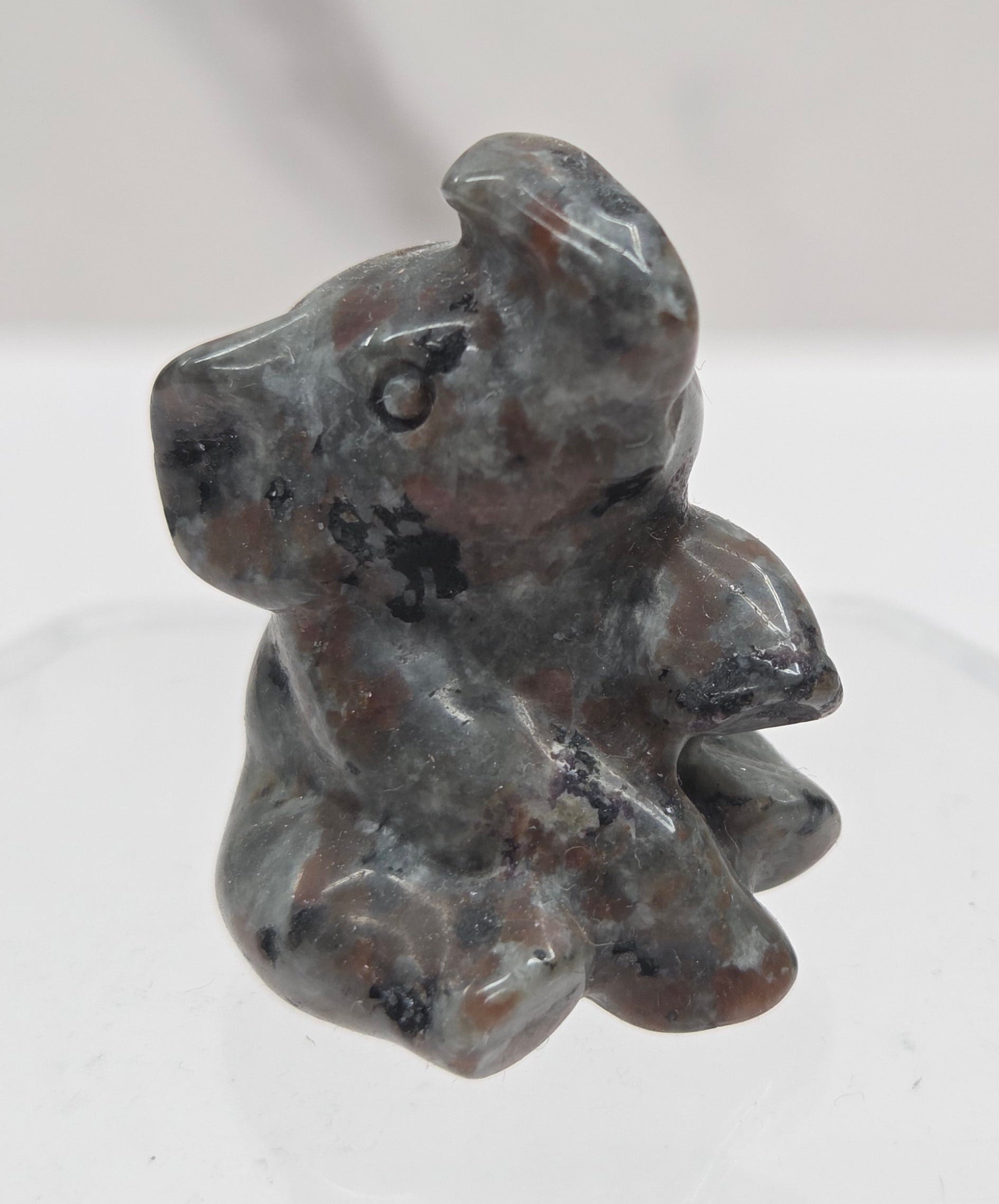 Multicolored sitting elephant carving on a white background