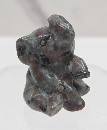 Multicolored sitting elephant carving on a white background