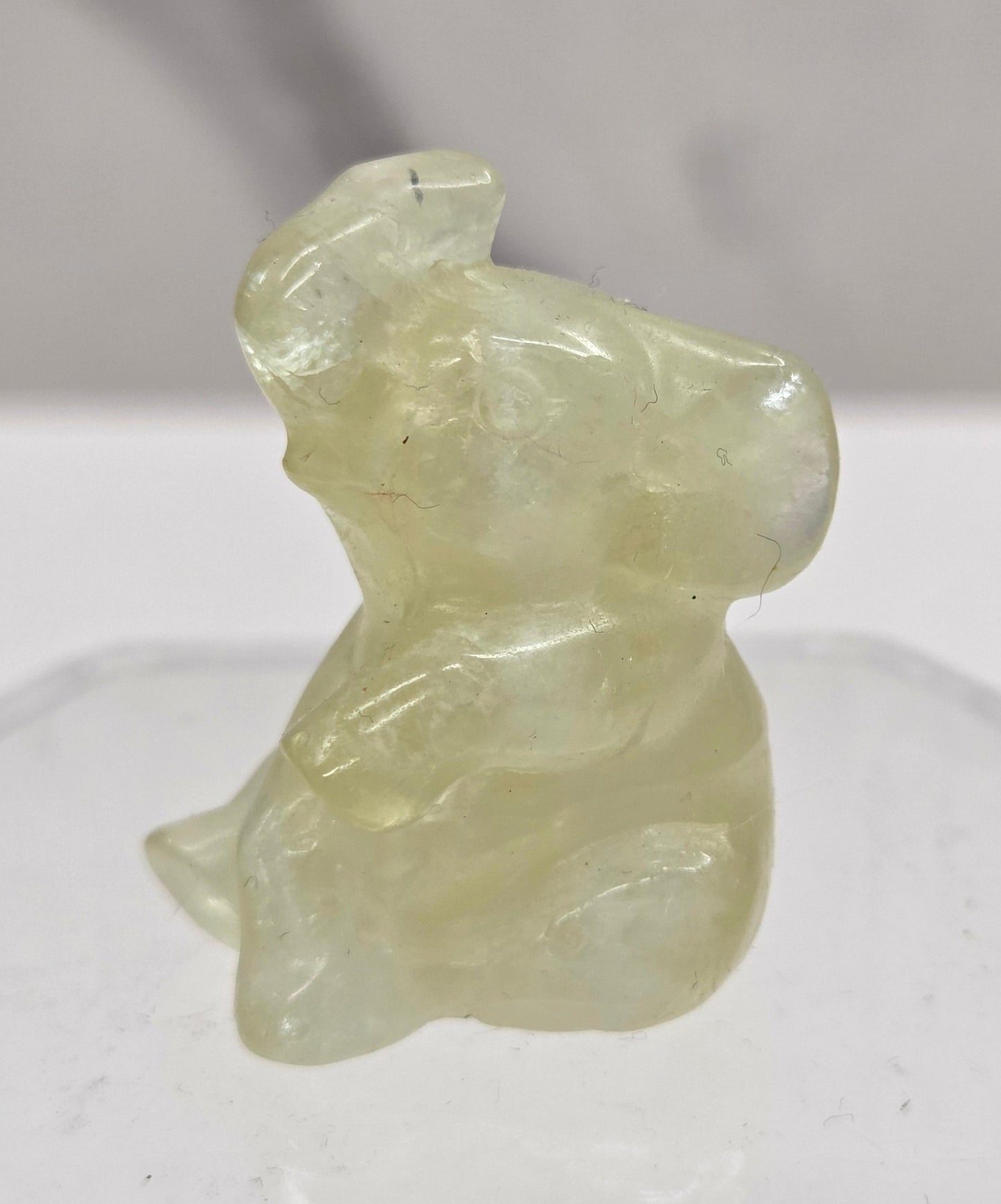 Citrine sitting elephant carving on a white background
