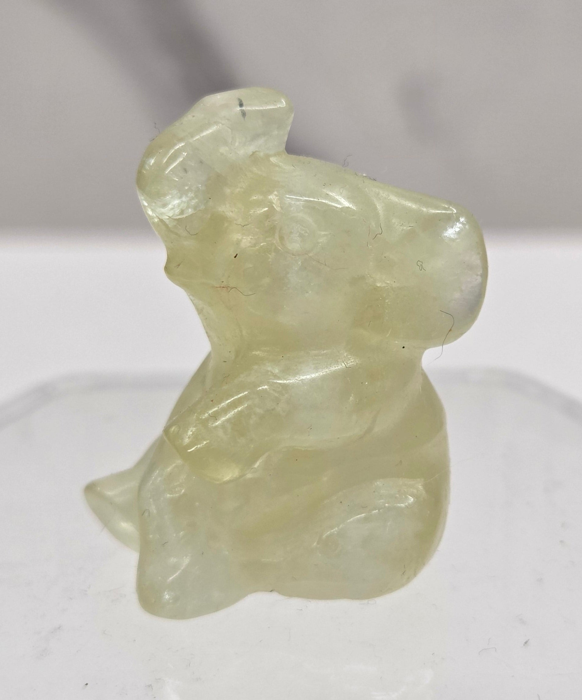 Citrine sitting elephant carving on a white background