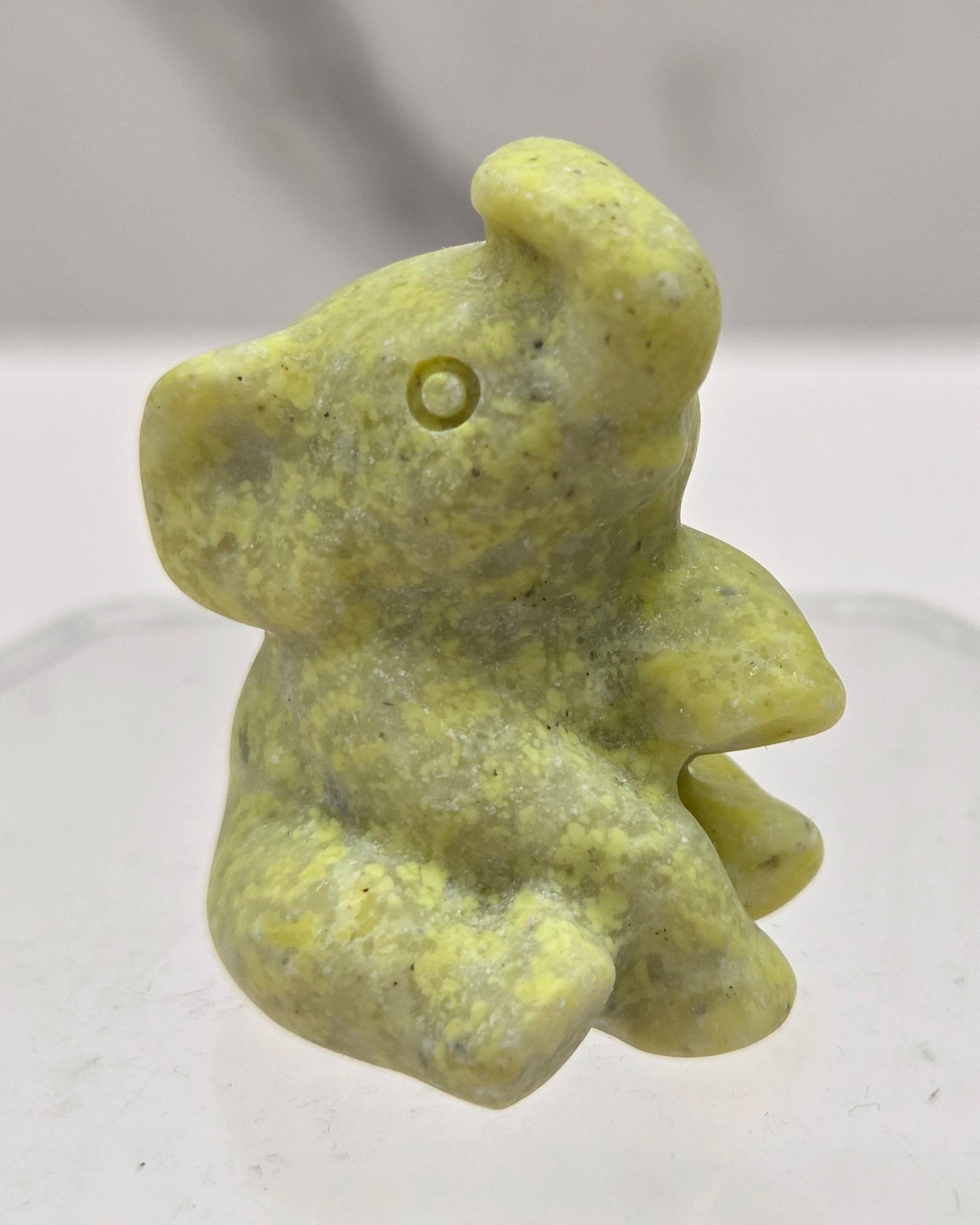 Yellow crystal sitting elephant carving on a white background