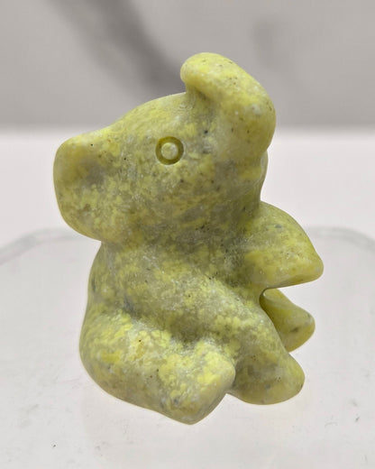 Yellow crystal sitting elephant carving on a white background