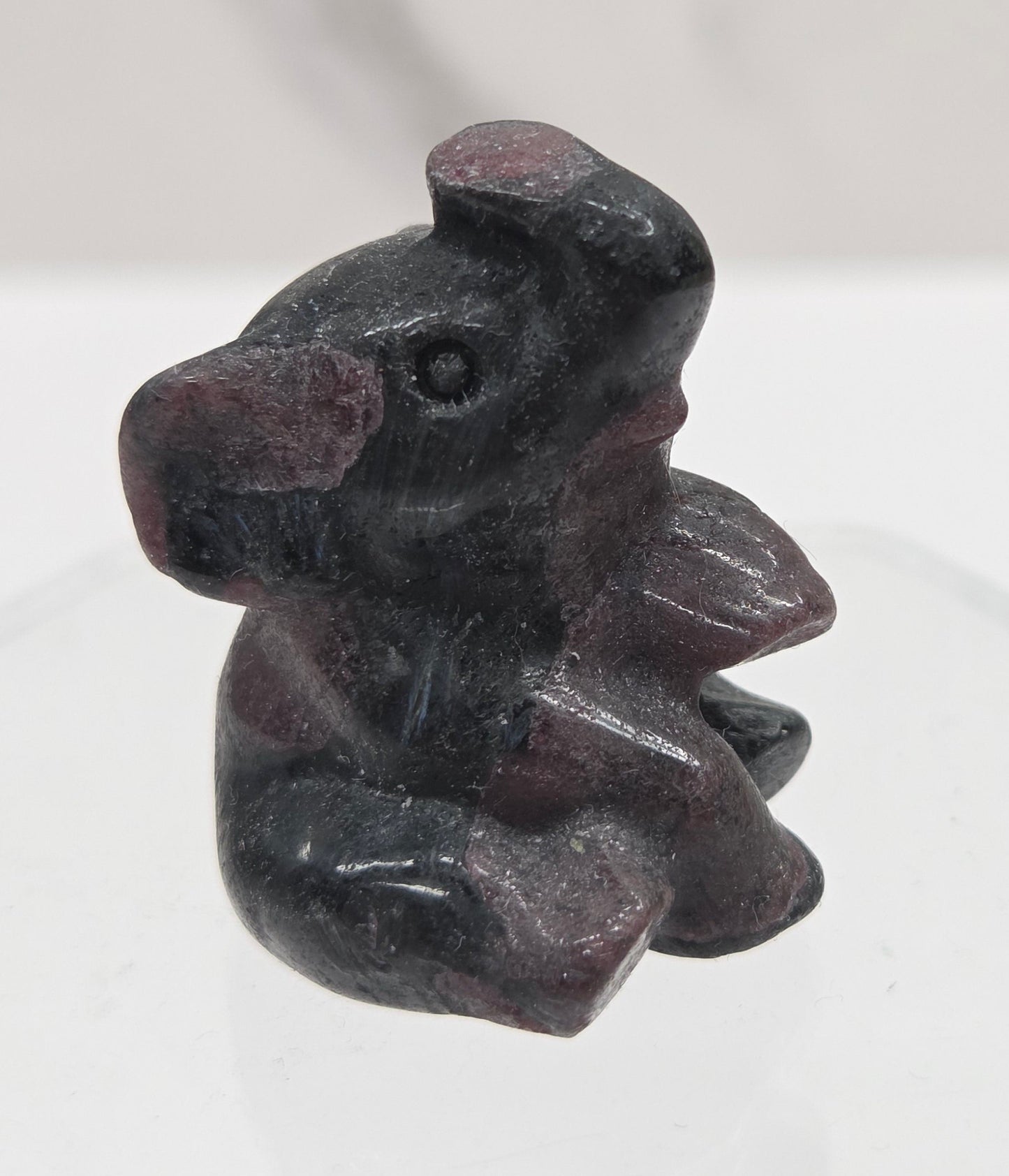 Black and red Garnet sitting elephant carving on a white background