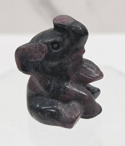 Black and red Garnet sitting elephant carving on a white background