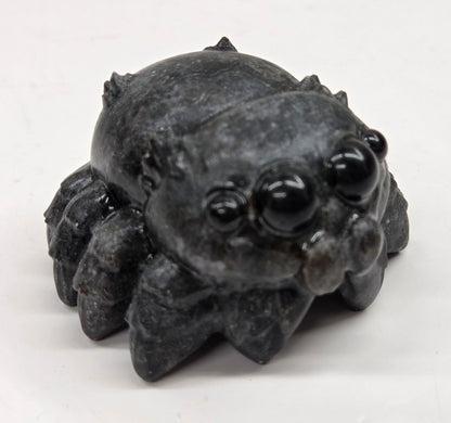 Black jumping spider carving on a white background