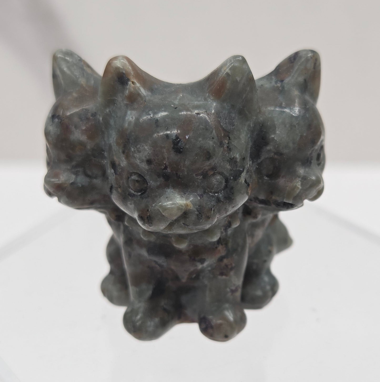 Yooperlite small crystal mythological cerberus animal figurines on a white surface