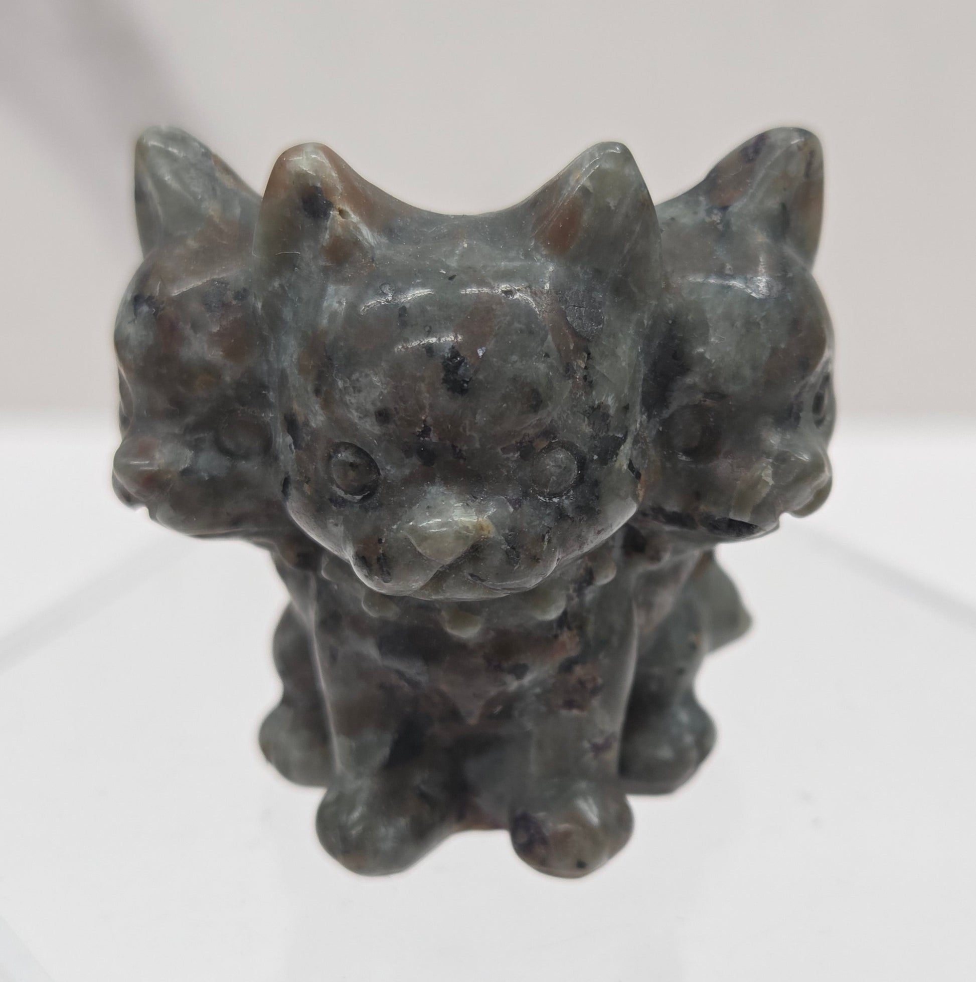 Yooperlite small crystal mythological cerberus animal figurines on a white surface